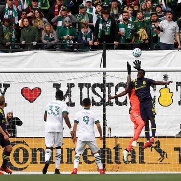 MLS goalie defending against a shot