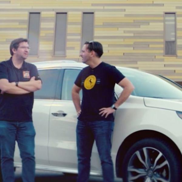 Dinner with Racers standing next to SUV