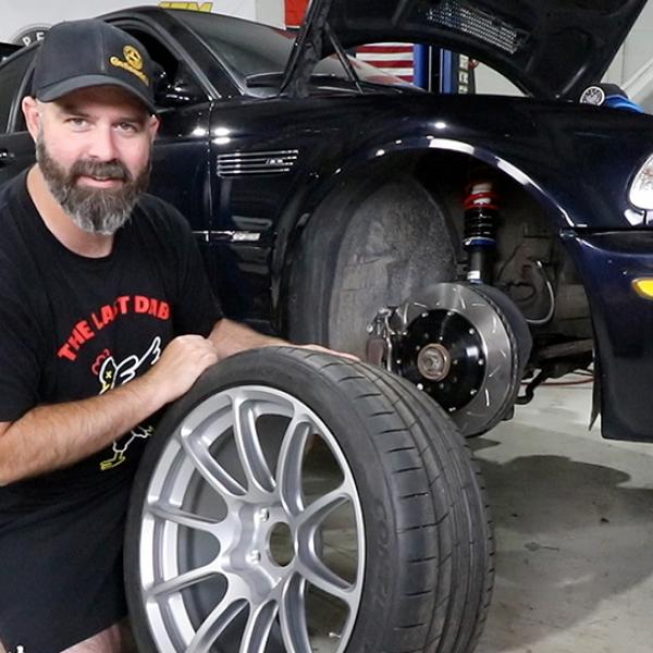 Speed academy team putting on a tire in the garage
